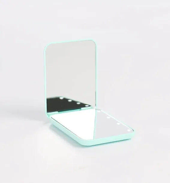 Portable GlowFold LED makeup mirror in green with foldable design